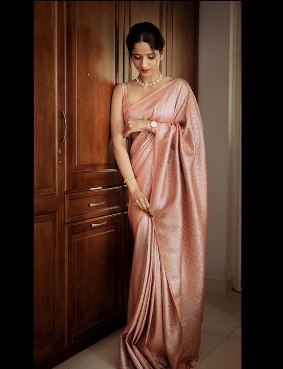 Rose gold silk saree with a soft metallic sheen, paired with a matching blouse, styled for an elegant and minimal festive look.