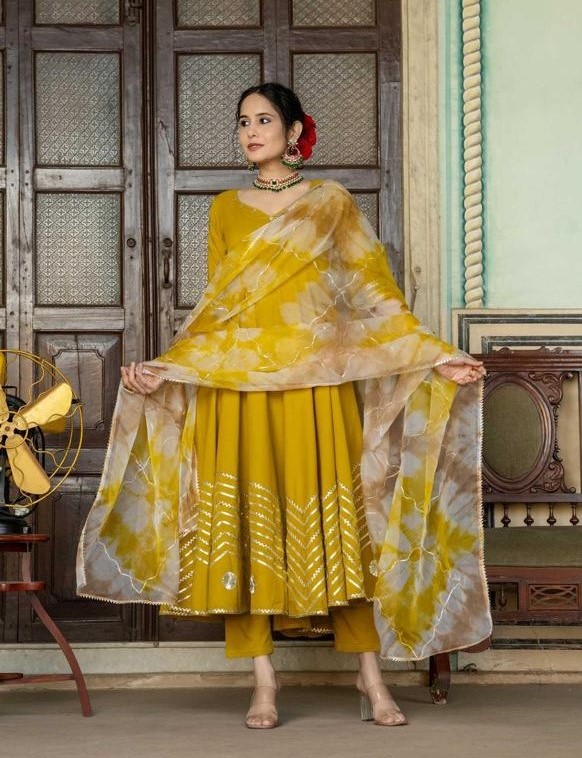 Mustard yellow Anarkali dress with flared silhouette, perfect for haldi ceremony, sangeet, or festive occasions.